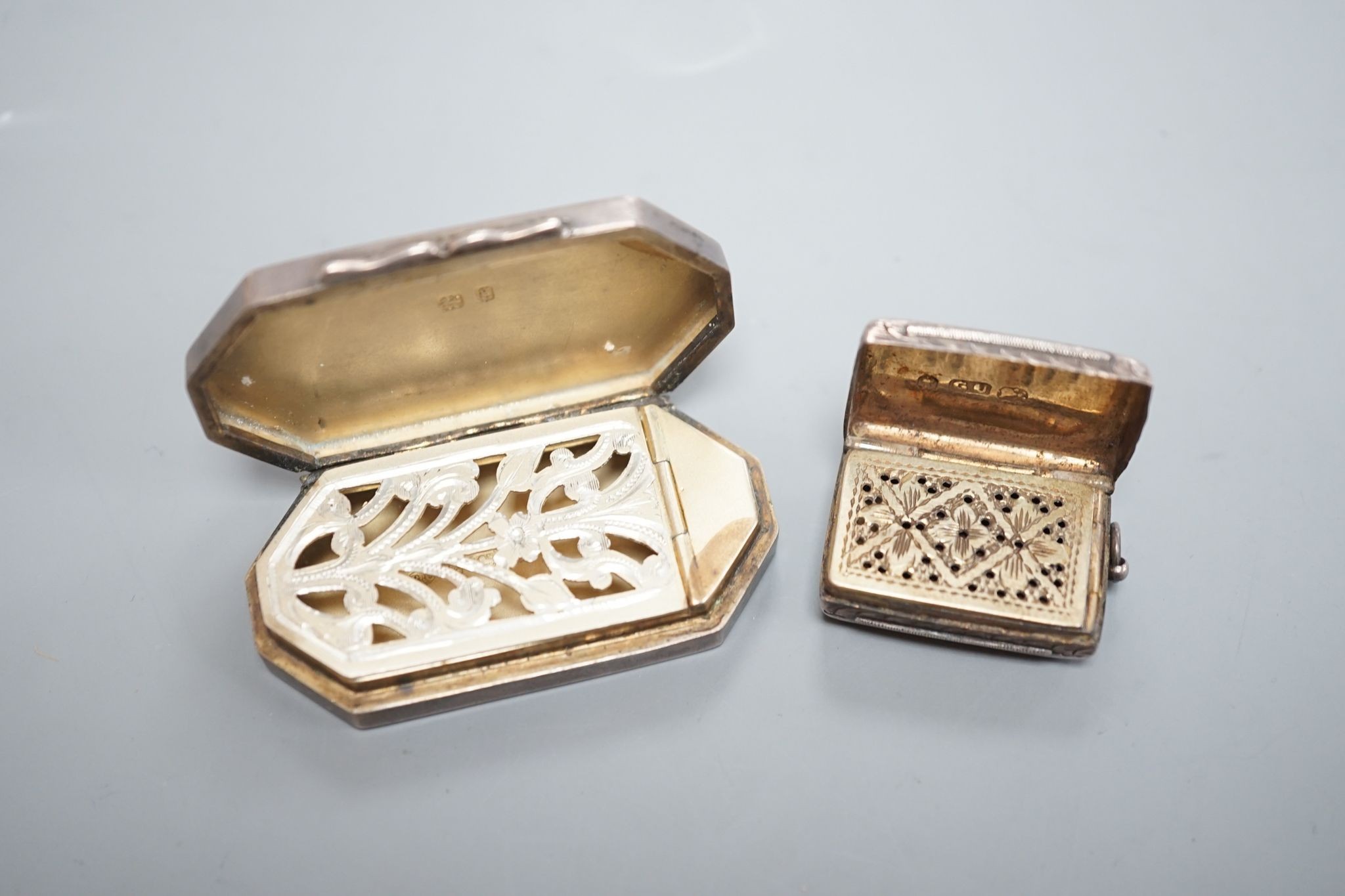 An Edwardian silver octagonal vinaigrette, with engraved sunburst decoration, maker, B.C Birmingham, 1906, 51mm and a smaller earlier vinaigrette by George Unite.